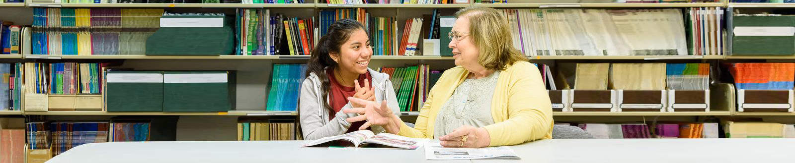 Older lady mentoring younger female student