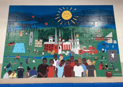Art mural on the wall showing people and images of Frederick